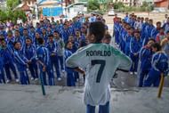 13-year-old Jetin Shrestha stands wearing the t-shirt that Cristiano Ronaldo sent him